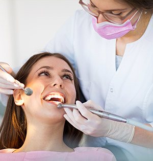 Woman Smiling during dental cleaning